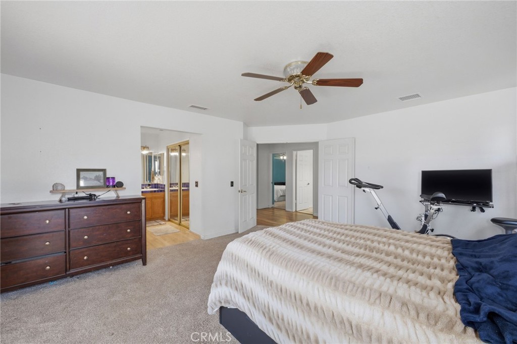 19992 Covell Street Riverside, CA 92508 - Photo 31 of 57 a bedroom with a bed and a flat screen tv