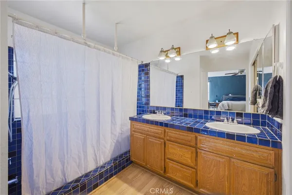 a bathroom with a granite countertop sink a toilet and a mirror