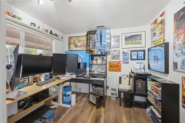 a view of a workspace with furniture and a window