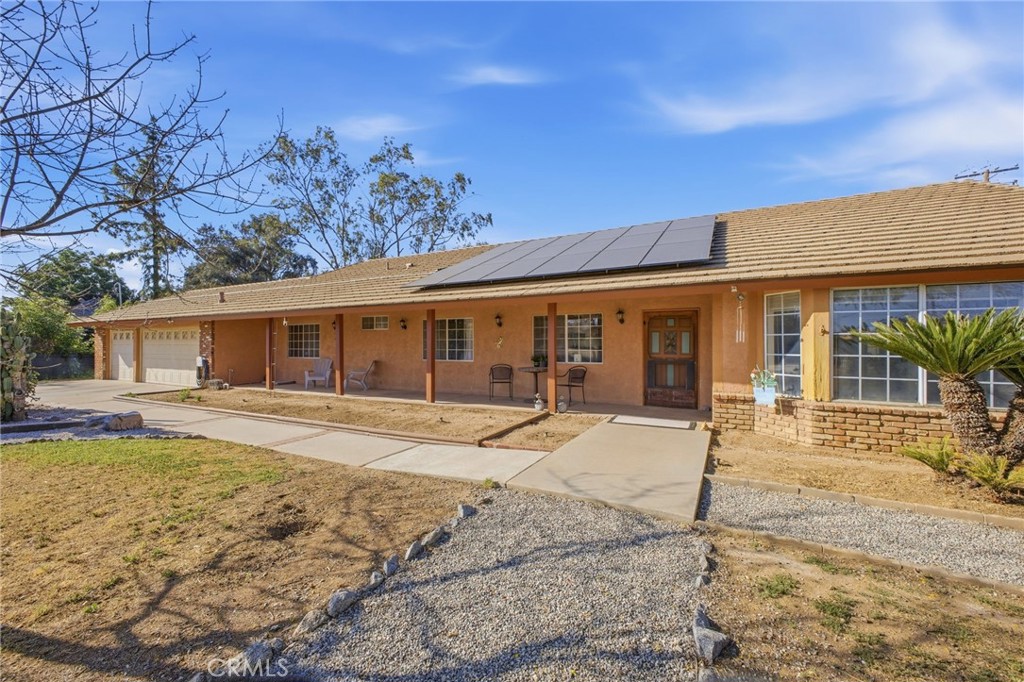 19992 Covell Street Riverside, CA 92508 - Photo 4 of 57 a front view of a house with a yard and potted plants