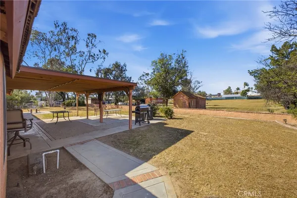a swimming pool with outdoor seating and yard