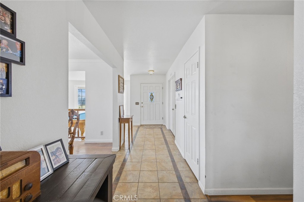 19992 Covell Street Riverside, CA 92508 - Photo 10 of 57 a view of a hallway with wooden floor and furniture