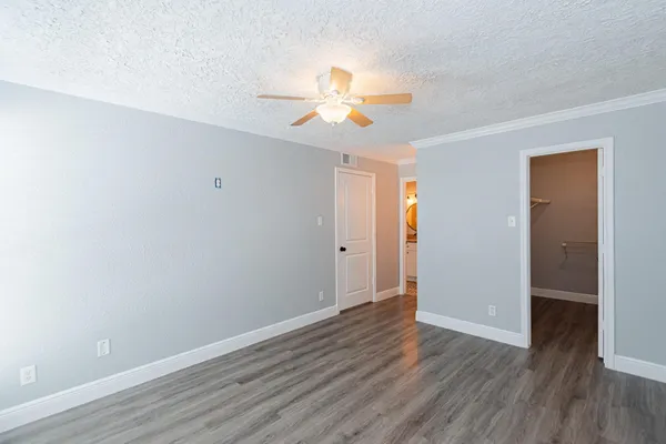 a view of an empty room with wooden floor