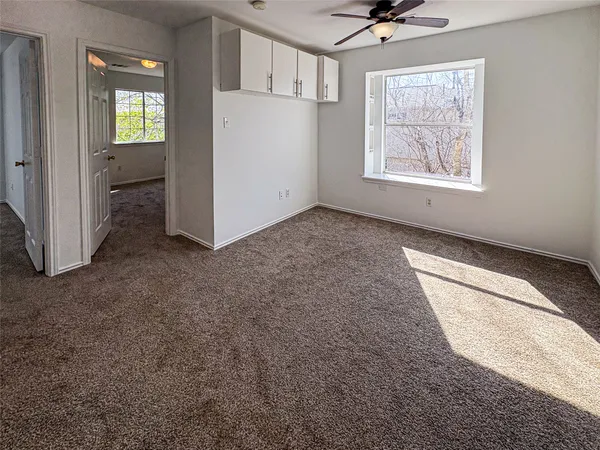 an empty room with windows and closet