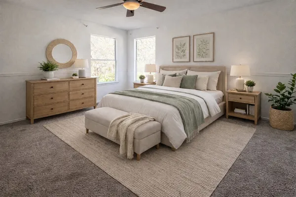 a spacious bedroom with a bed and a dresser
