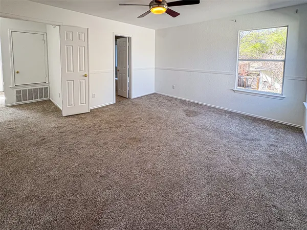 an empty room with windows and closet