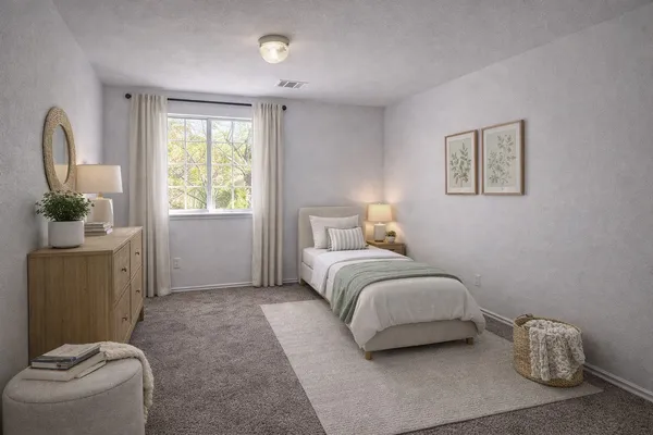 a bedroom with a bed and a couch