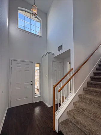 a view of an entryway with wooden floor
