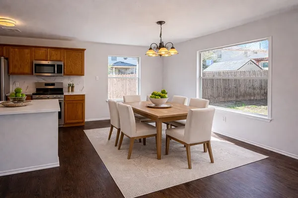 a dining room with furniture a window and wooden floor