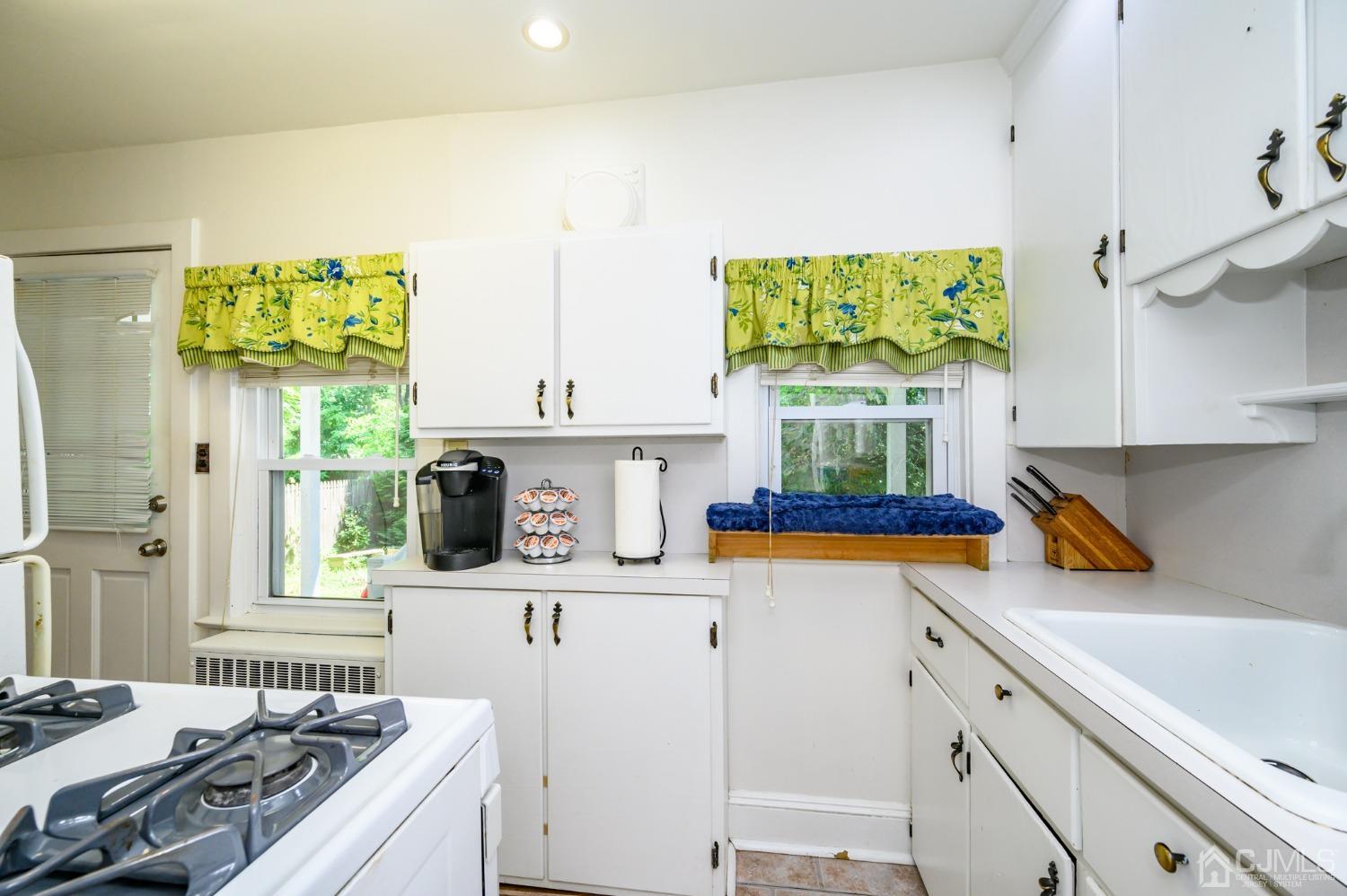 1860 Pennington Road Ewing, NJ 08638 - Photo 14 of 35 a kitchen with stainless steel appliances a sink a stove and a refrigerator