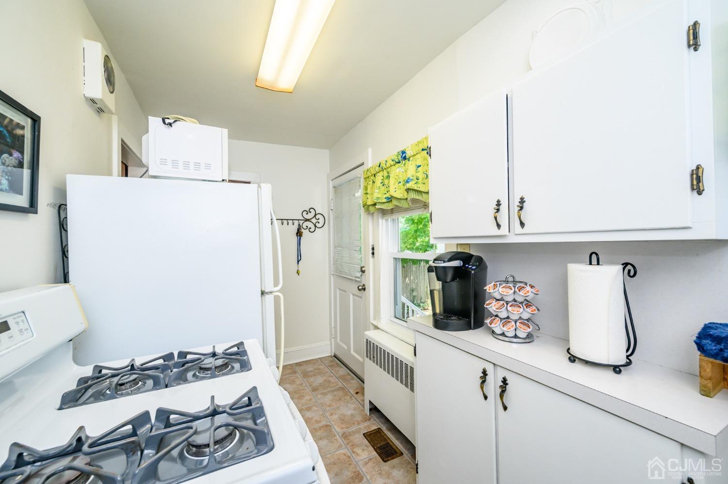 1860 Pennington Road Ewing, NJ 08638 - Photo 15 of 35 a kitchen with a refrigerator and a stove