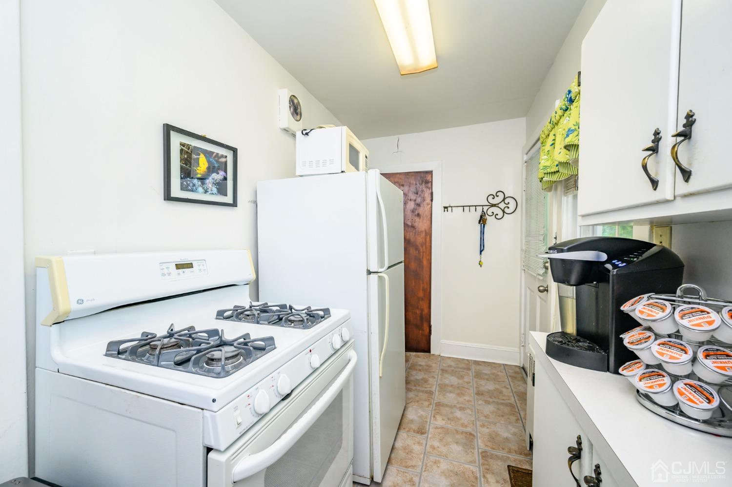 1860 Pennington Road Ewing, NJ 08638 - Photo 16 of 35 a kitchen with a sink stove and refrigerator