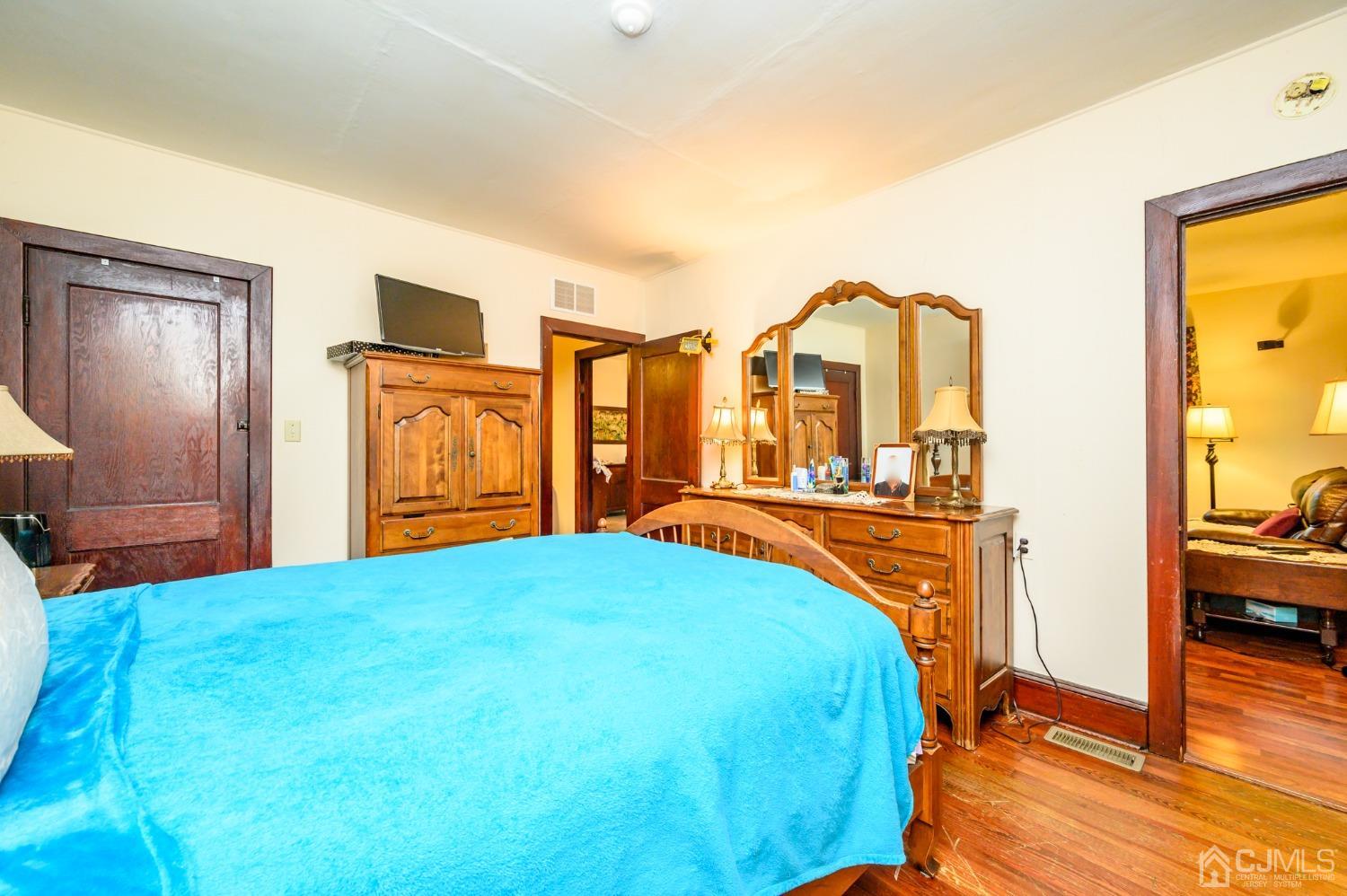 1860 Pennington Road Ewing, NJ 08638 - Photo 18 of 35 a bedroom with a bed and dresser with mirror