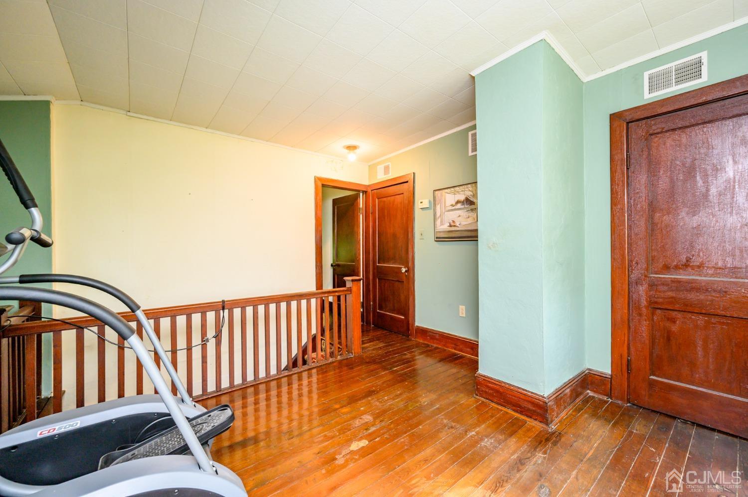 1860 Pennington Road Ewing, NJ 08638 - Photo 26 of 35 a view of a hallway with wooden floor and stairs