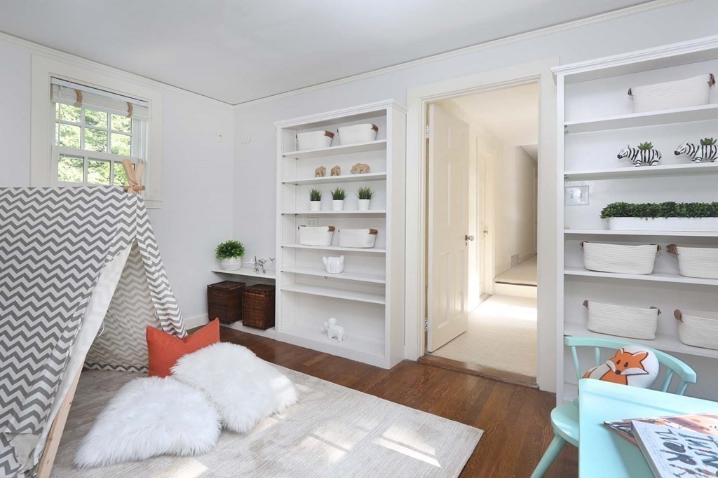 11 Laurel Road Brookline, MA 02467 - Photo 11 of 24 a living room with furniture and a book shelf