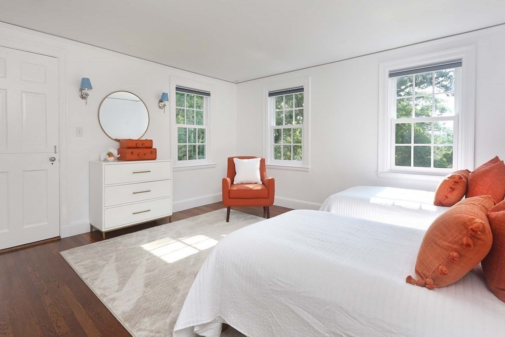 11 Laurel Road Brookline, MA 02467 - Photo 12 of 24 a bedroom with a bed and window with chair