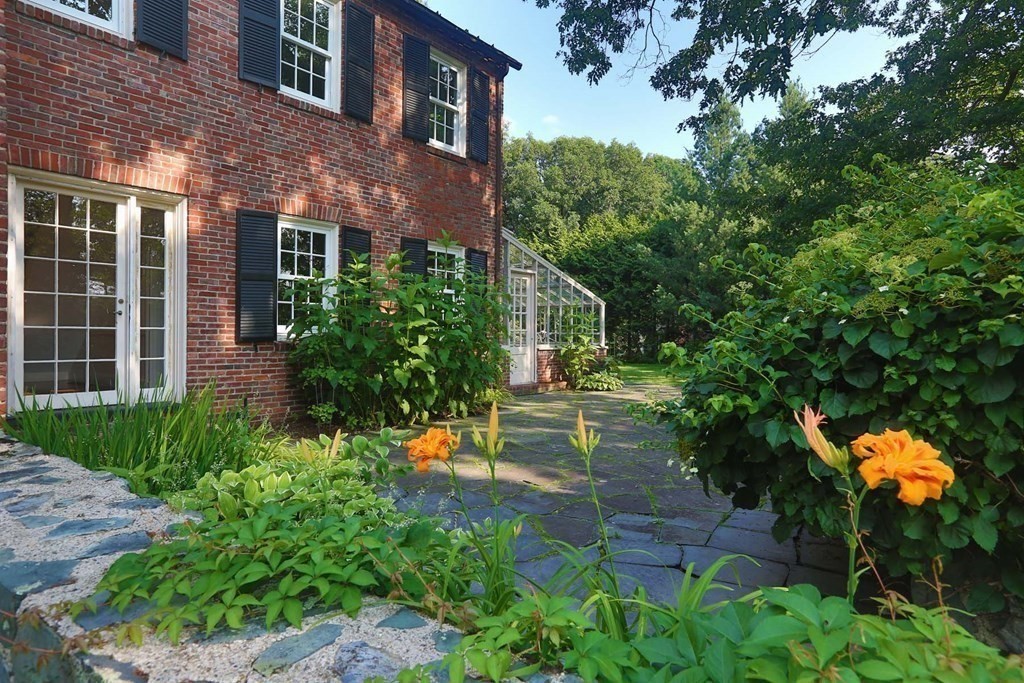 11 Laurel Road Brookline, MA 02467 - Photo 14 of 24 a front view of a house with a yard and a fountain