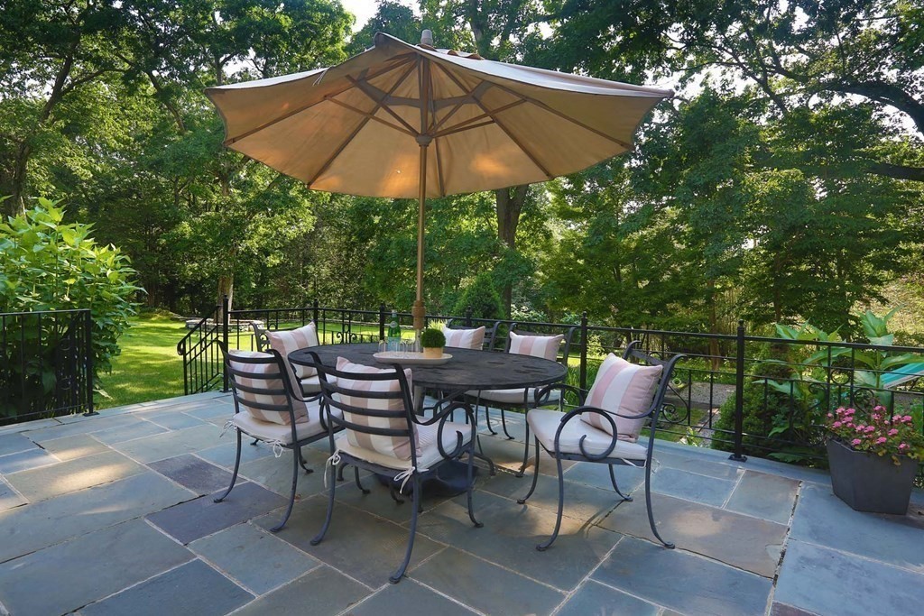 11 Laurel Road Brookline, MA 02467 - Photo 22 of 24 a patio with a patio table and chairs