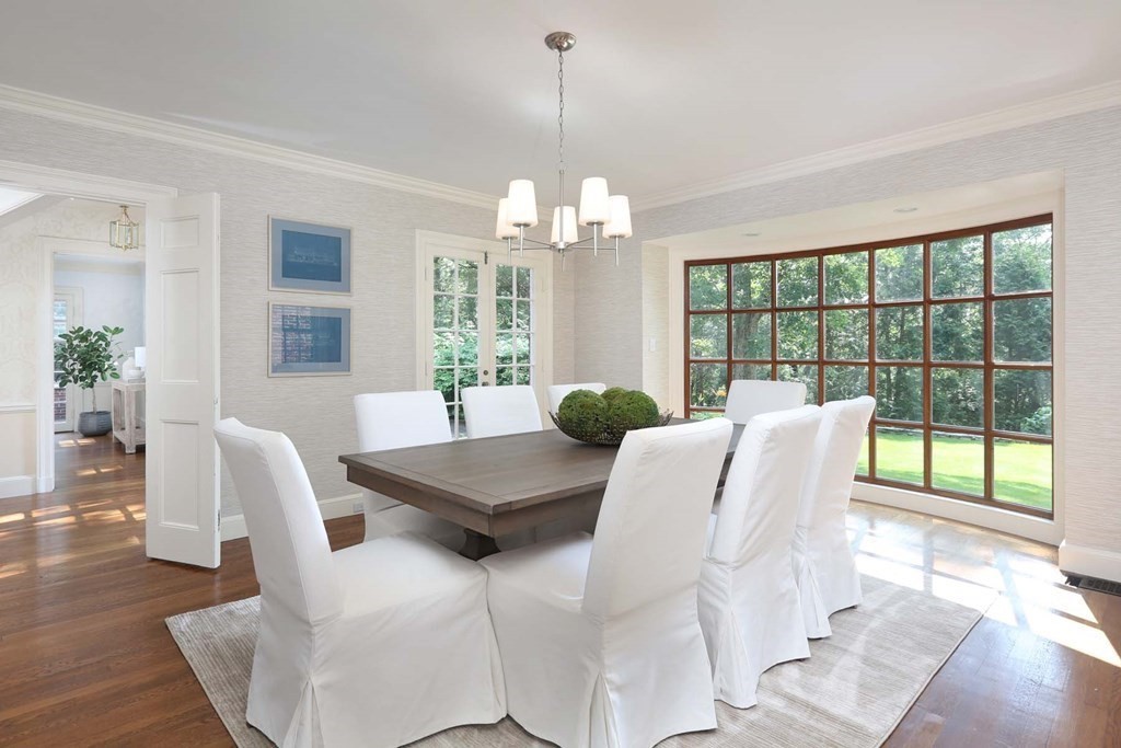 11 Laurel Road Brookline, MA 02467 - Photo 3 of 24 a view of a dining room with furniture a chandelier and wooden floor