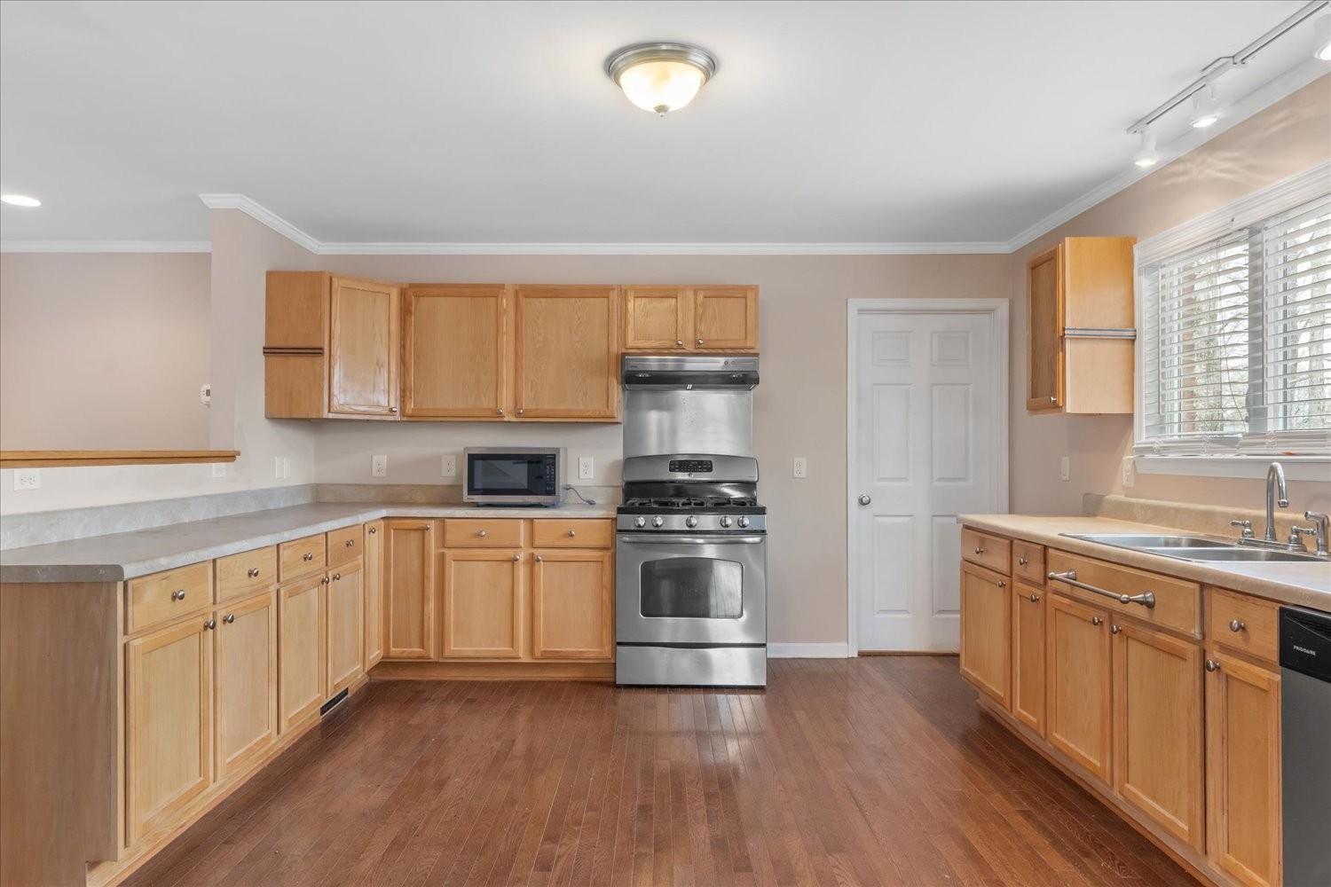 732 Tiger Bennett Road Hampshire, TN 38461 - Photo 17 of 35 a kitchen with stainless steel appliances granite countertop a stove and a sink
