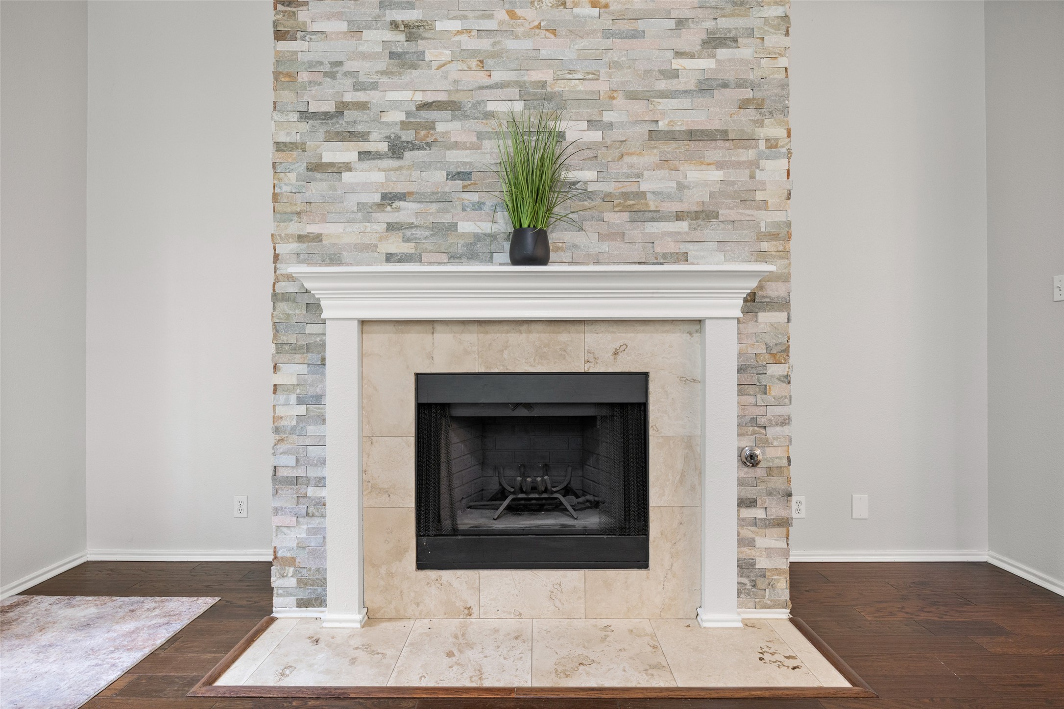 8610 Axis Drive Austin, TX 78749 - Photo 3 of 29 a living room with a fireplace and a potted plant