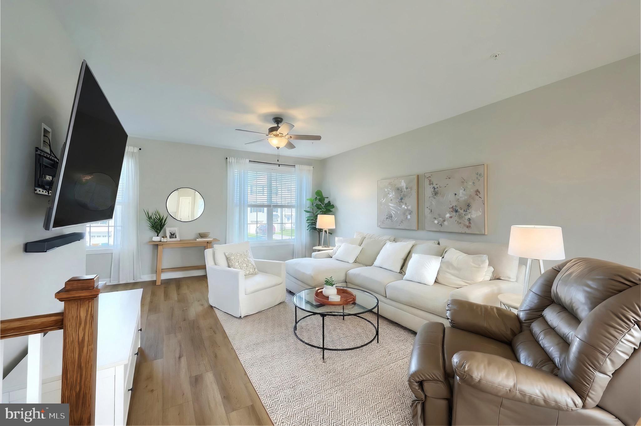 54 Coop Lane Hanover, PA 17331 - Photo 11 of 34 a living room with furniture a flat screen tv and a floor to ceiling window
