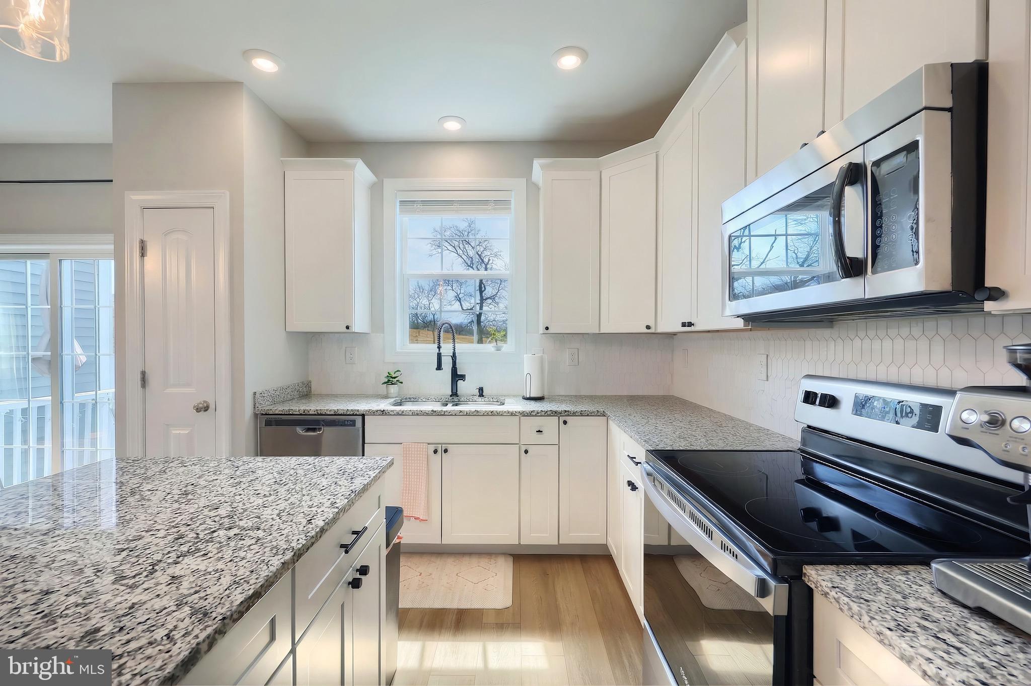 54 Coop Lane Hanover, PA 17331 - Photo 18 of 34 a kitchen with stainless steel appliances granite countertop a stove a sink and a microwave