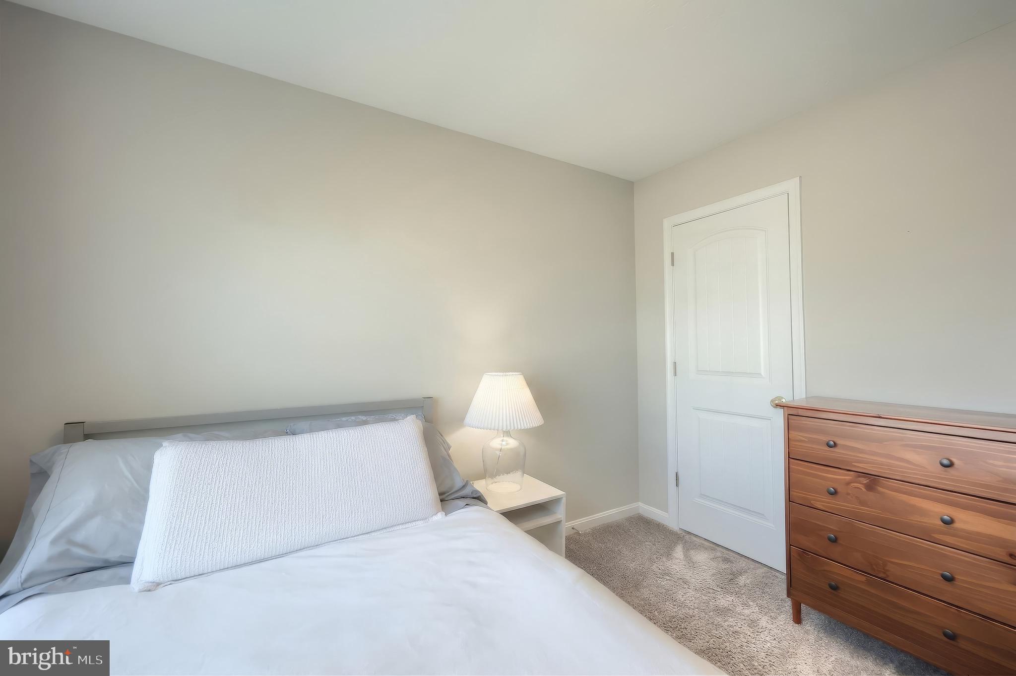 54 Coop Lane Hanover, PA 17331 - Photo 24 of 34 a bedroom with a bed and a lamp on dresser