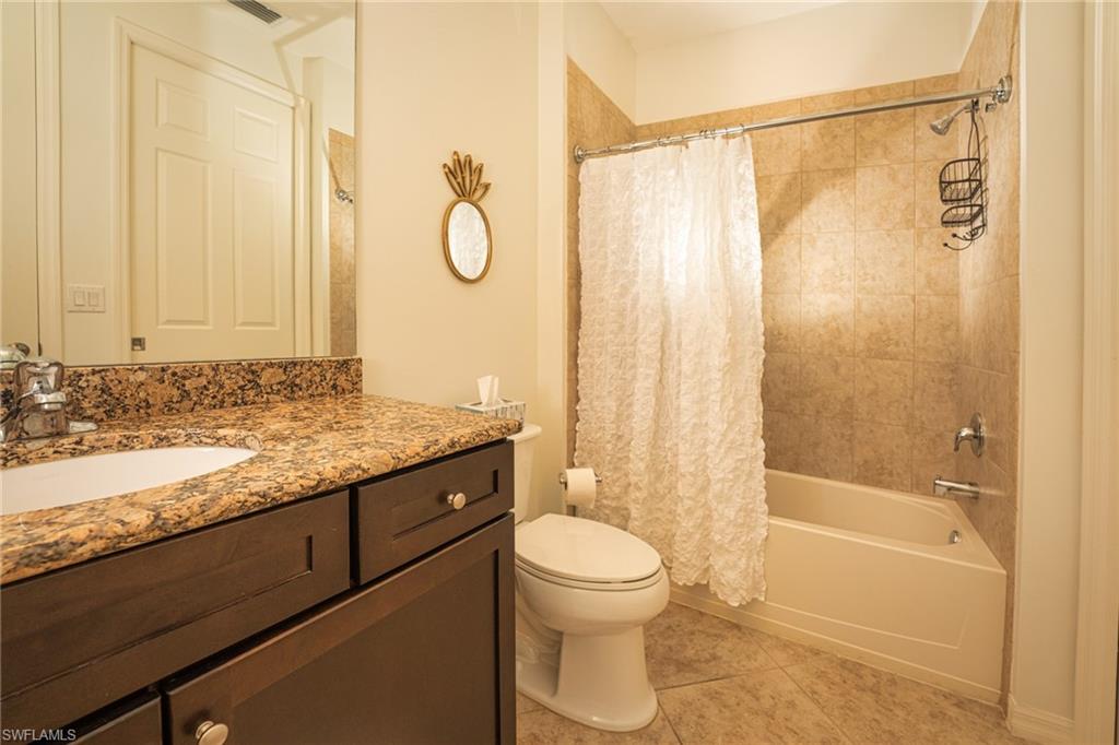 8986 Cambria Circle, Unit 22 Naples, FL 34113 - Photo 17 of 20 Full bathroom featuring tile patterned floors, shower / bath combo, toilet, and vanity