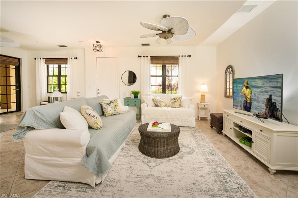 8986 Cambria Circle, Unit 22 Naples, FL 34113 - Photo 3 of 20 Living room featuring ceiling fan, a wealth of natural light, and light tile patterned floors