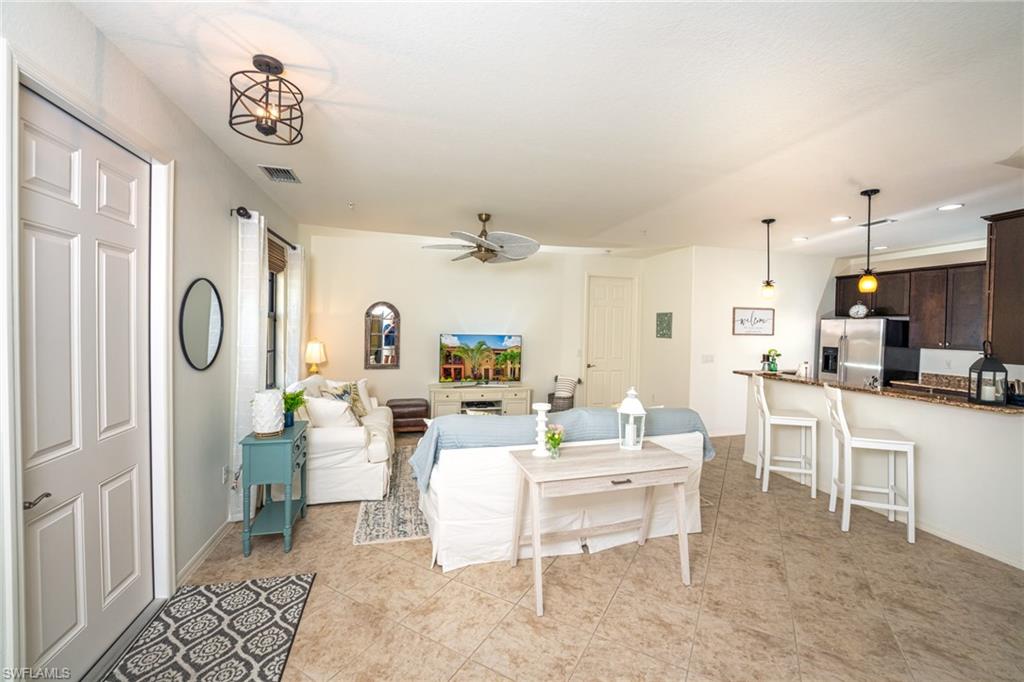 8986 Cambria Circle, Unit 22 Naples, FL 34113 - Photo 4 of 20 Tiled living room with ceiling fan