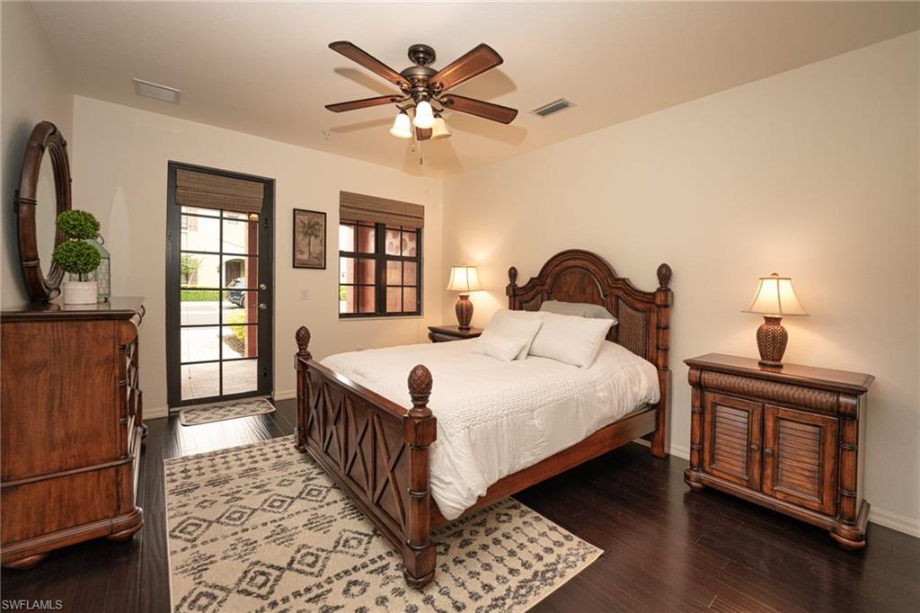 8986 Cambria Circle, Unit 22 Naples, FL 34113 - Photo 9 of 20 Bedroom featuring hardwood / wood-style flooring, access to exterior, and ceiling fan