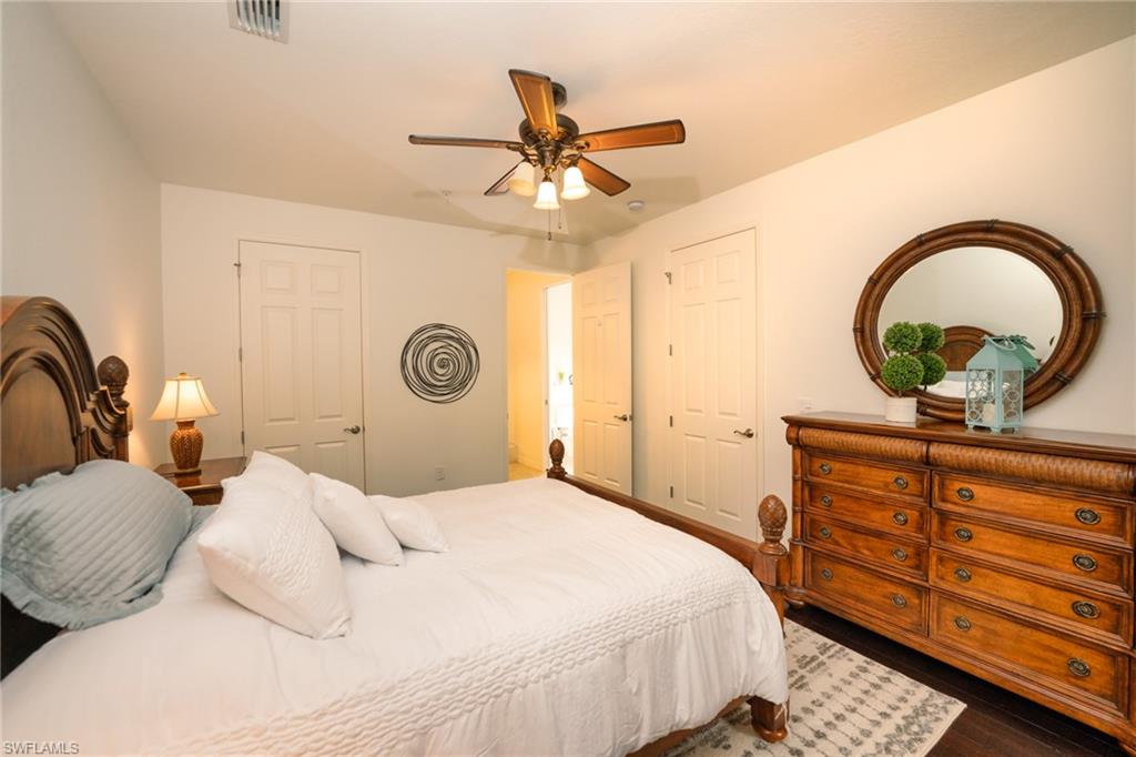 8986 Cambria Circle, Unit 22 Naples, FL 34113 - Photo 10 of 20 Bedroom with dark wood-type flooring and ceiling fan