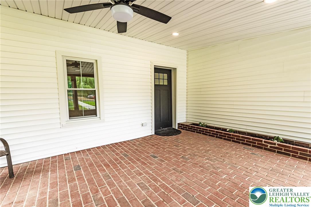 72 Allegheny Road Mount Bethel, PA 18343 - Photo 5 of 72 A classic brick patio with a vibrant planter box offers a tranquil outdoor escape.