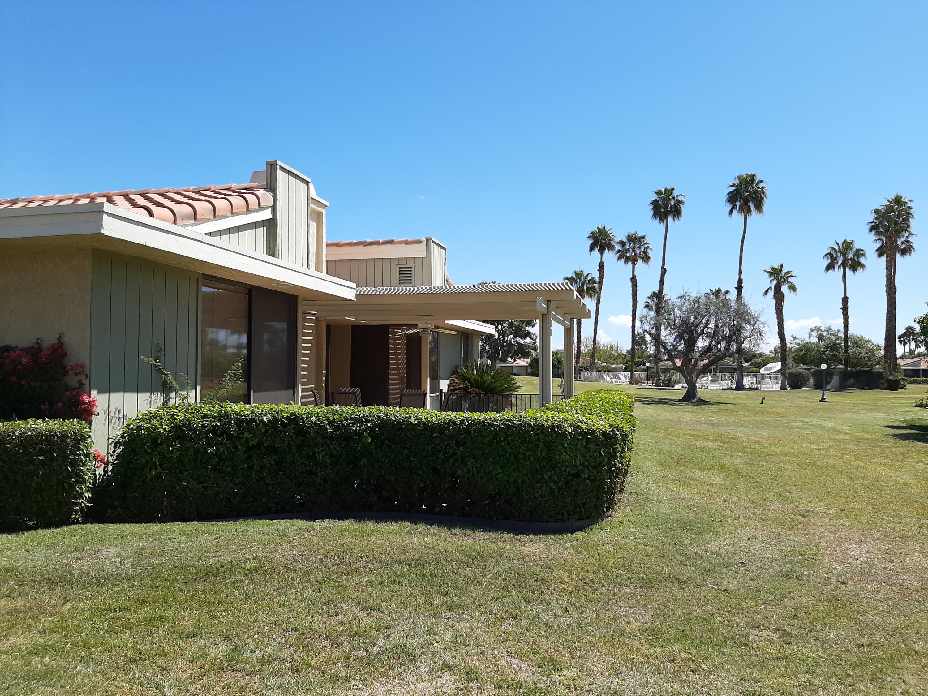 72385 Beverly Way Rancho Mirage, CA 92270 - Photo 11 of 24 a front view of a house with a garden