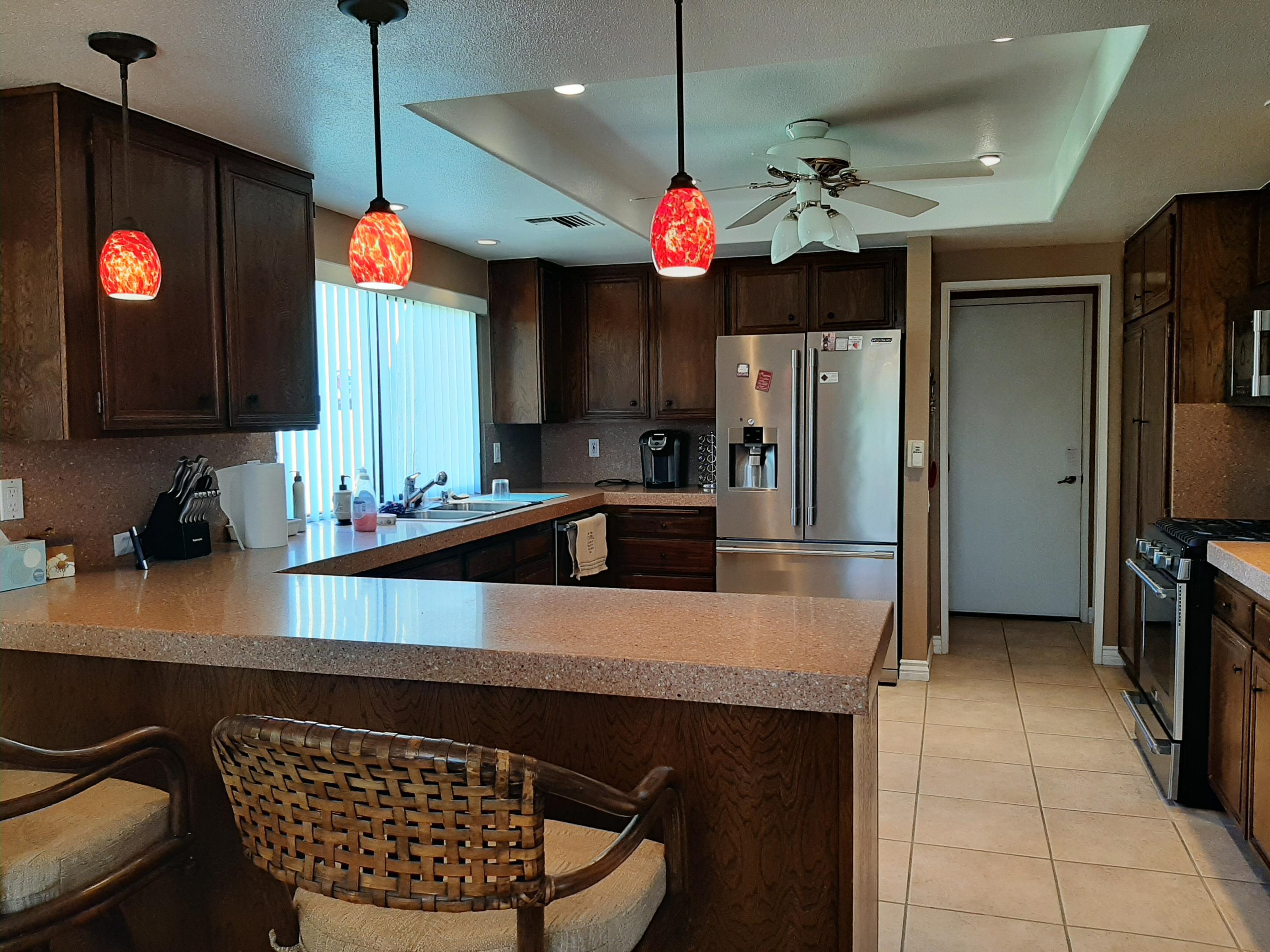 72385 Beverly Way Rancho Mirage, CA 92270 - Photo 17 of 24 a kitchen with a refrigerator a sink and a table