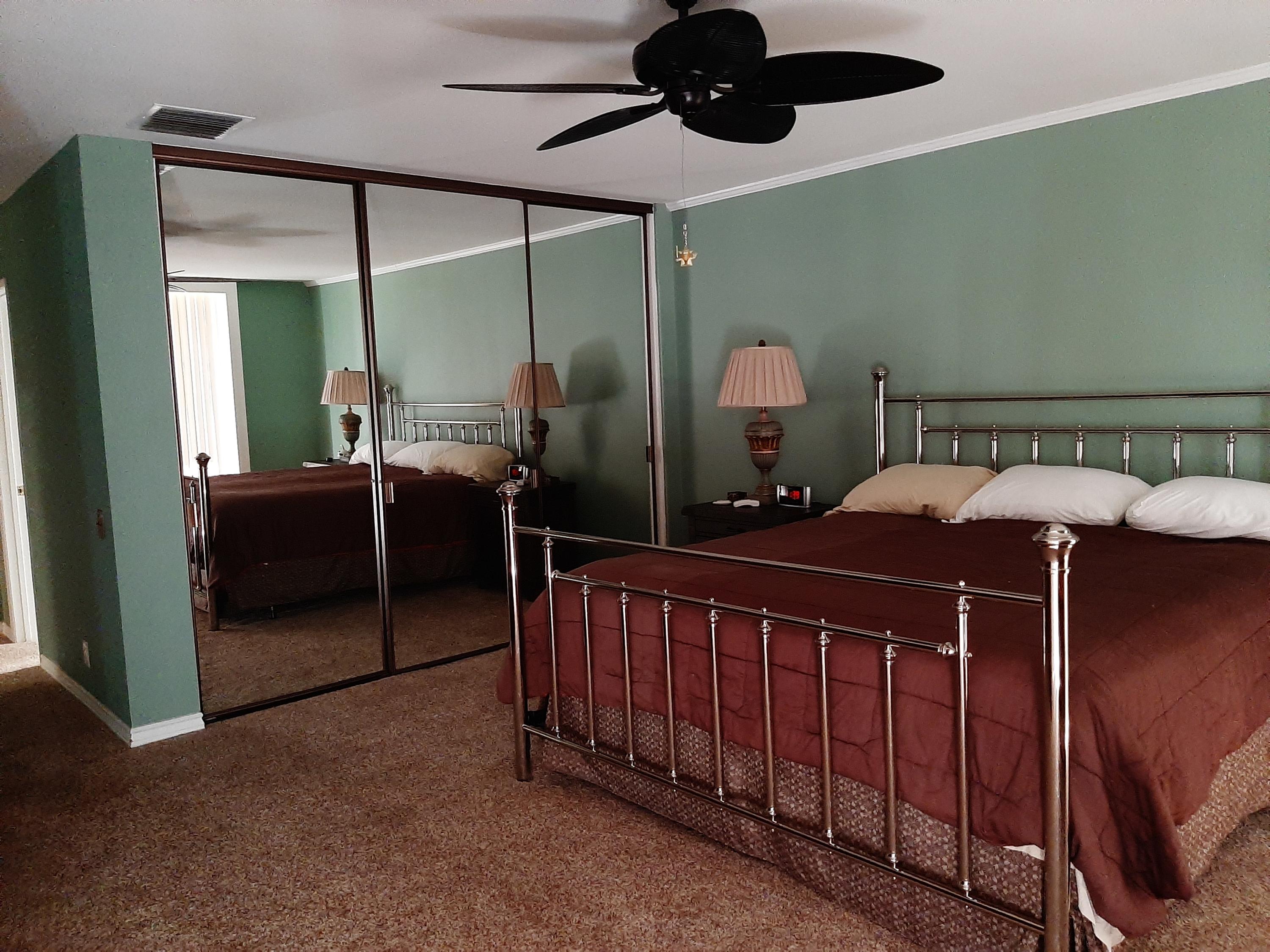 72385 Beverly Way Rancho Mirage, CA 92270 - Photo 22 of 24 a bedroom with bed and a chandelier