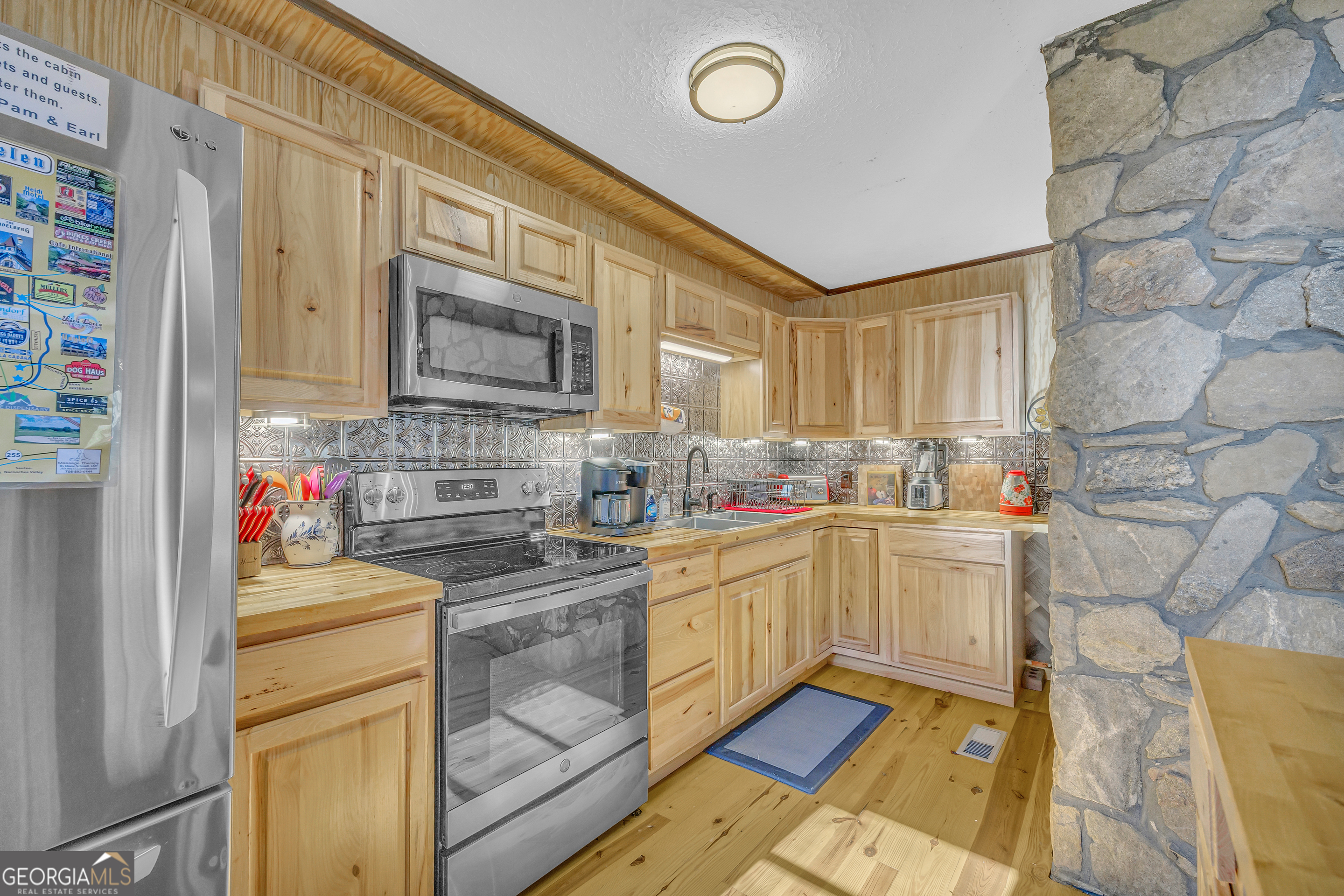243 Ridge Road Helen, GA 30545 - Photo 24 of 82 a kitchen with granite countertop a sink a stove and cabinets