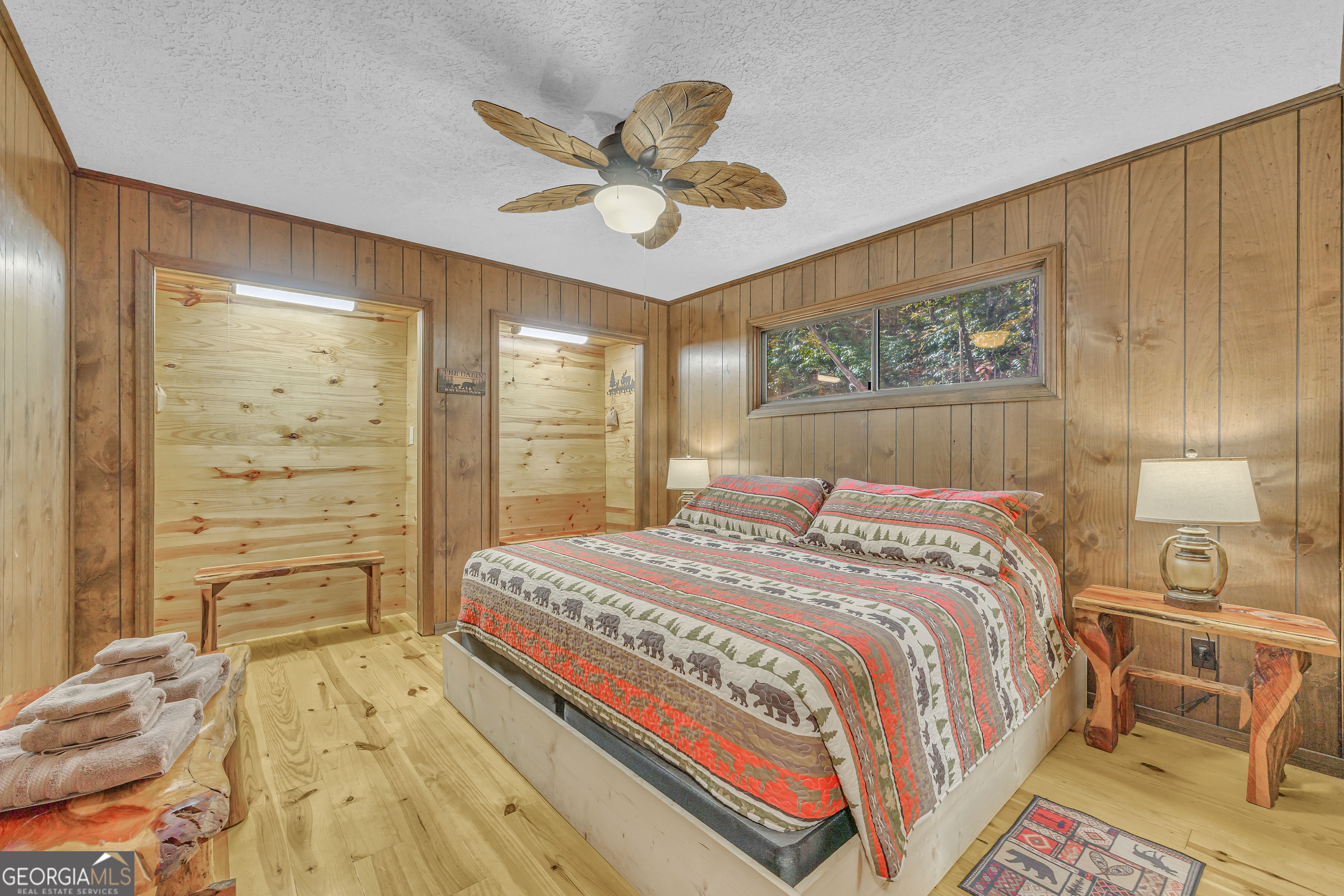 243 Ridge Road Helen, GA 30545 - Photo 30 of 82 a bedroom with a bed and a chandelier