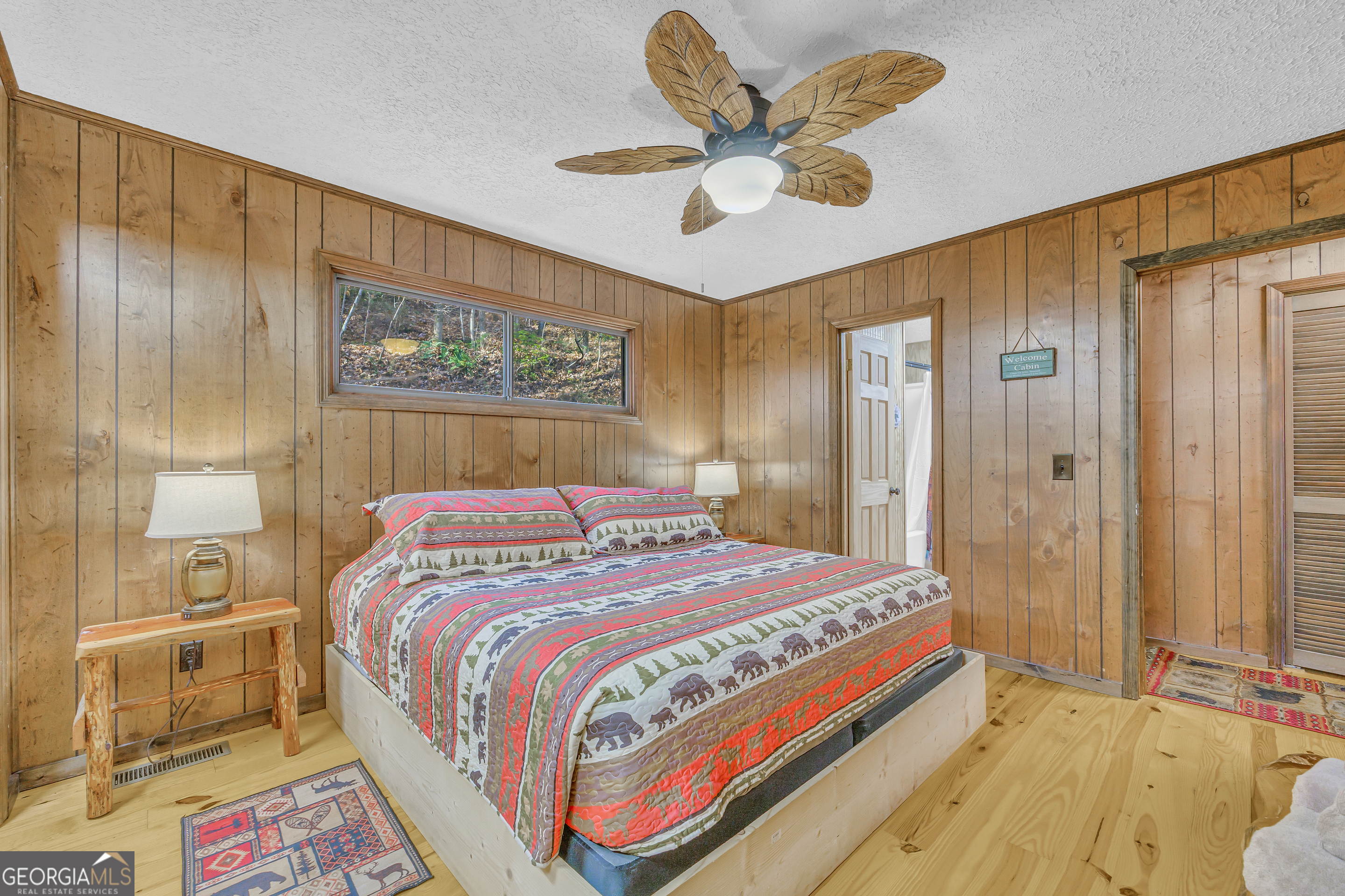 243 Ridge Road Helen, GA 30545 - Photo 31 of 82 a bedroom with a bed and a chandelier