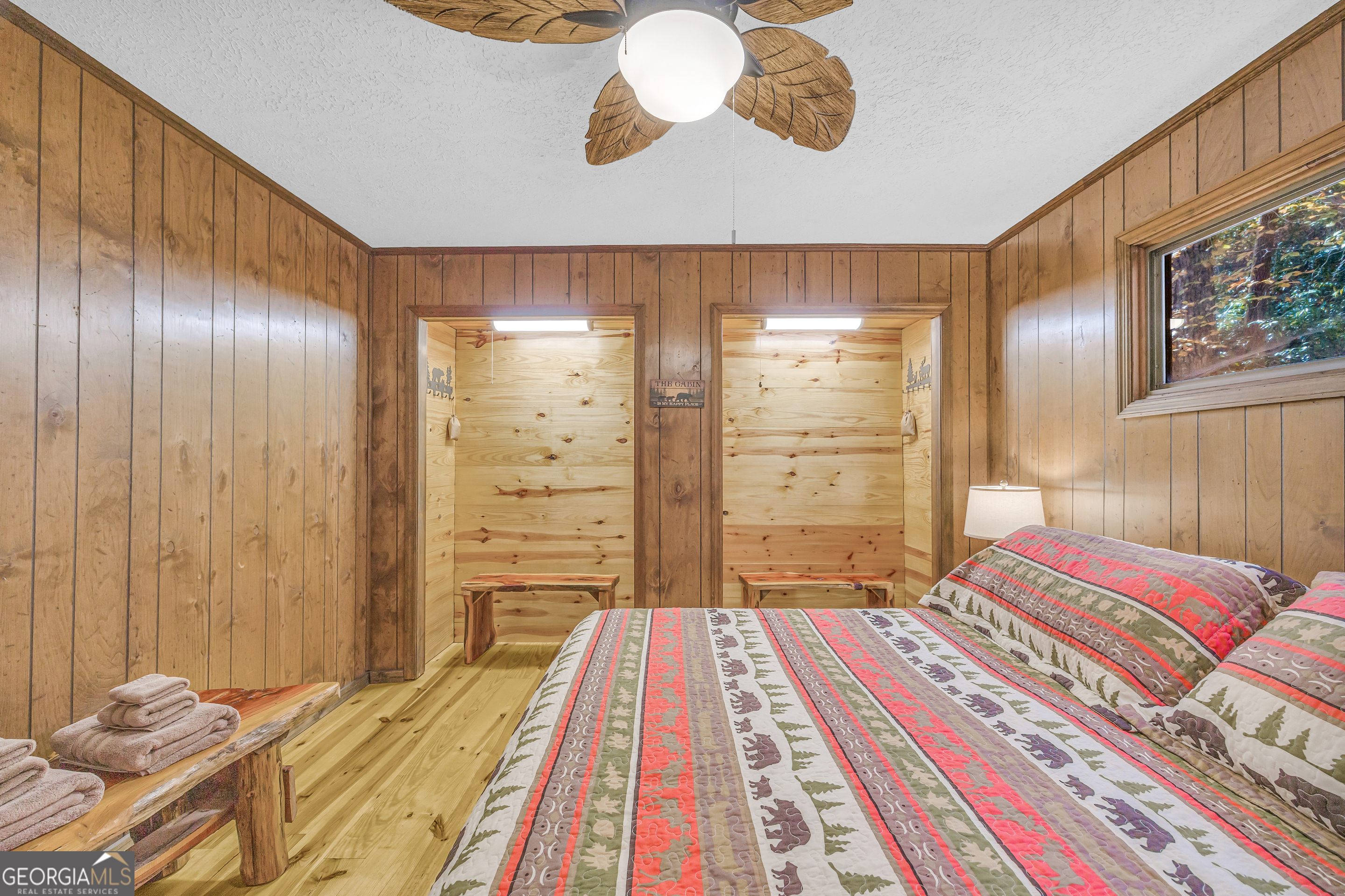 243 Ridge Road Helen, GA 30545 - Photo 35 of 82 a bedroom with a bed and a chandelier