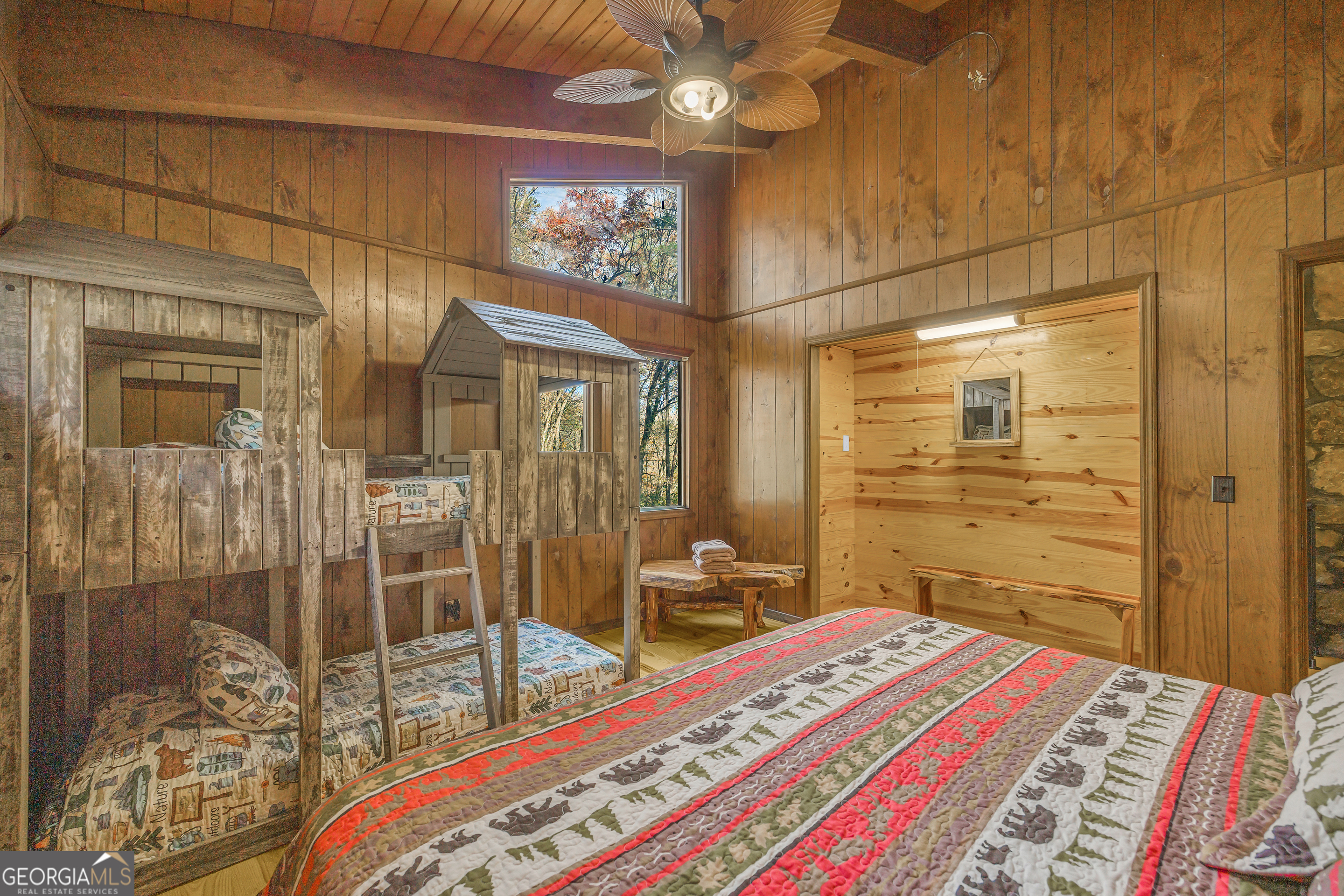 243 Ridge Road Helen, GA 30545 - Photo 40 of 82 a bedroom with a bed and a chandelier