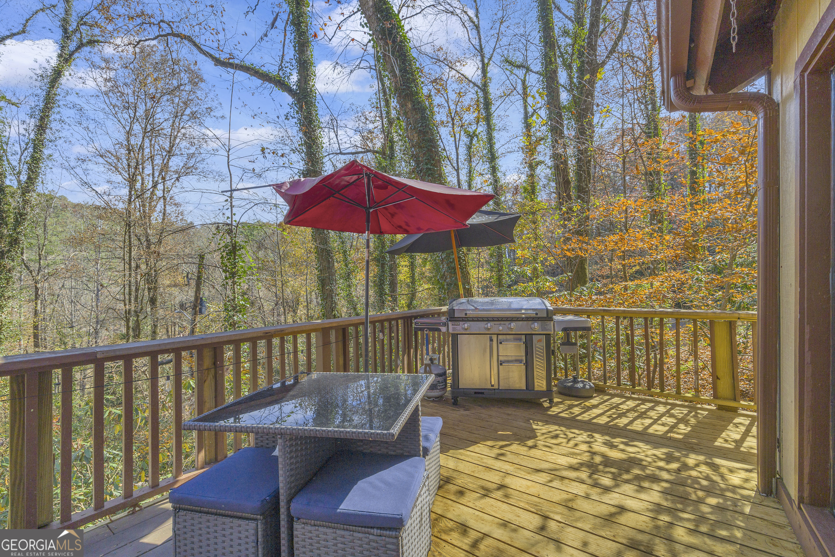 243 Ridge Road Helen, GA 30545 - Photo 6 of 82 a view of a balcony with two chairs and a barbeque