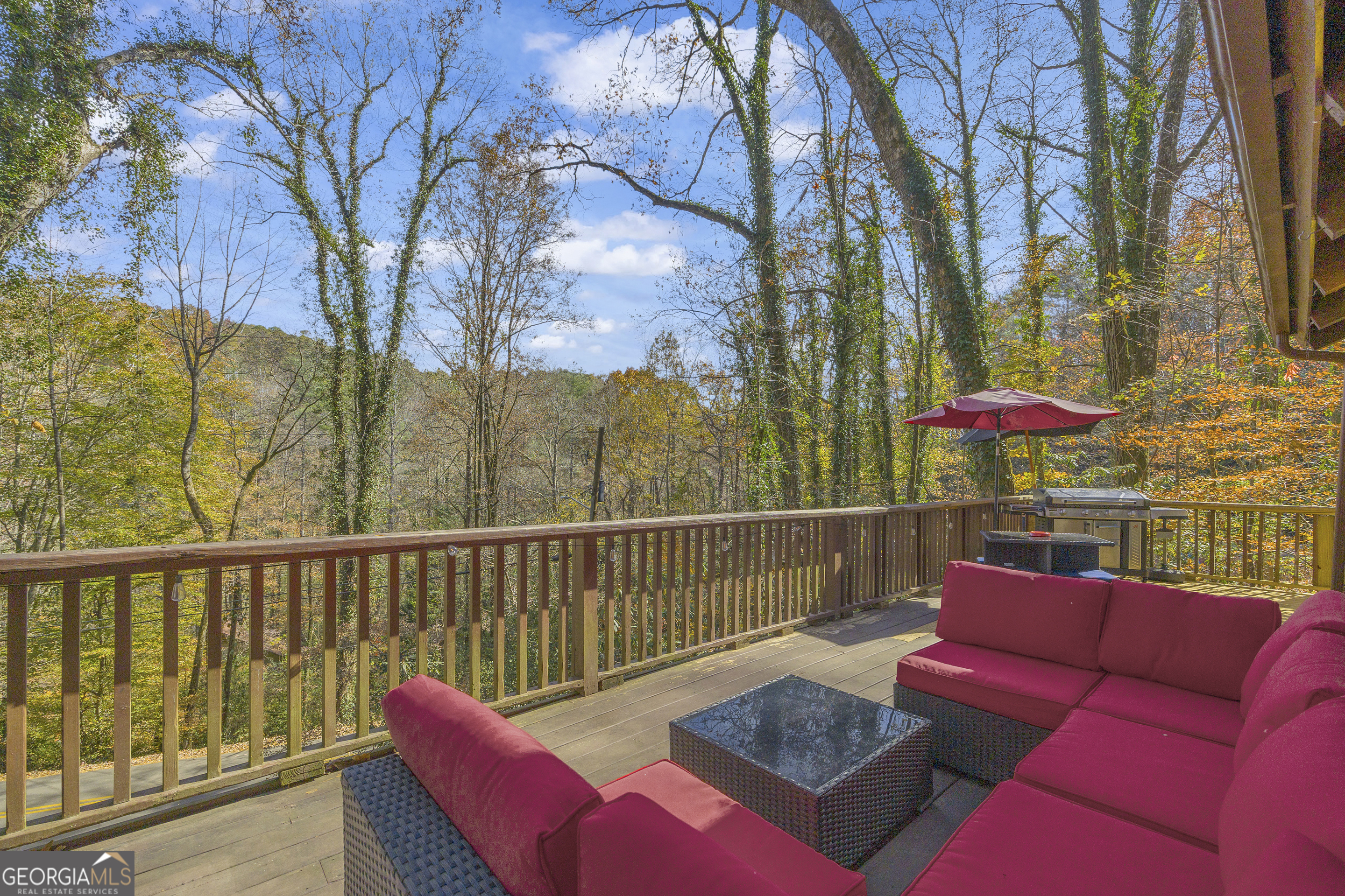 243 Ridge Road Helen, GA 30545 - Photo 7 of 82 a view of a deck with couches table and chairs and wooden floor