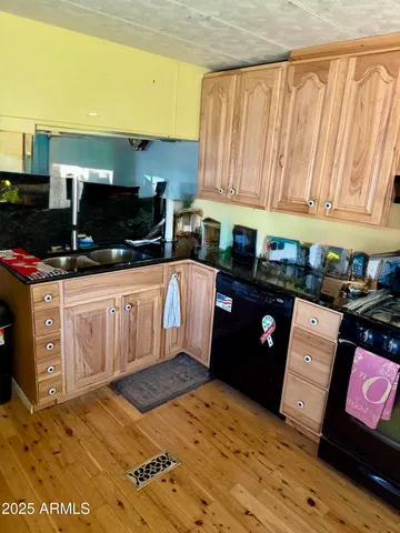 a kitchen with stainless steel appliances kitchen island granite countertop a stove a sink and a microwave