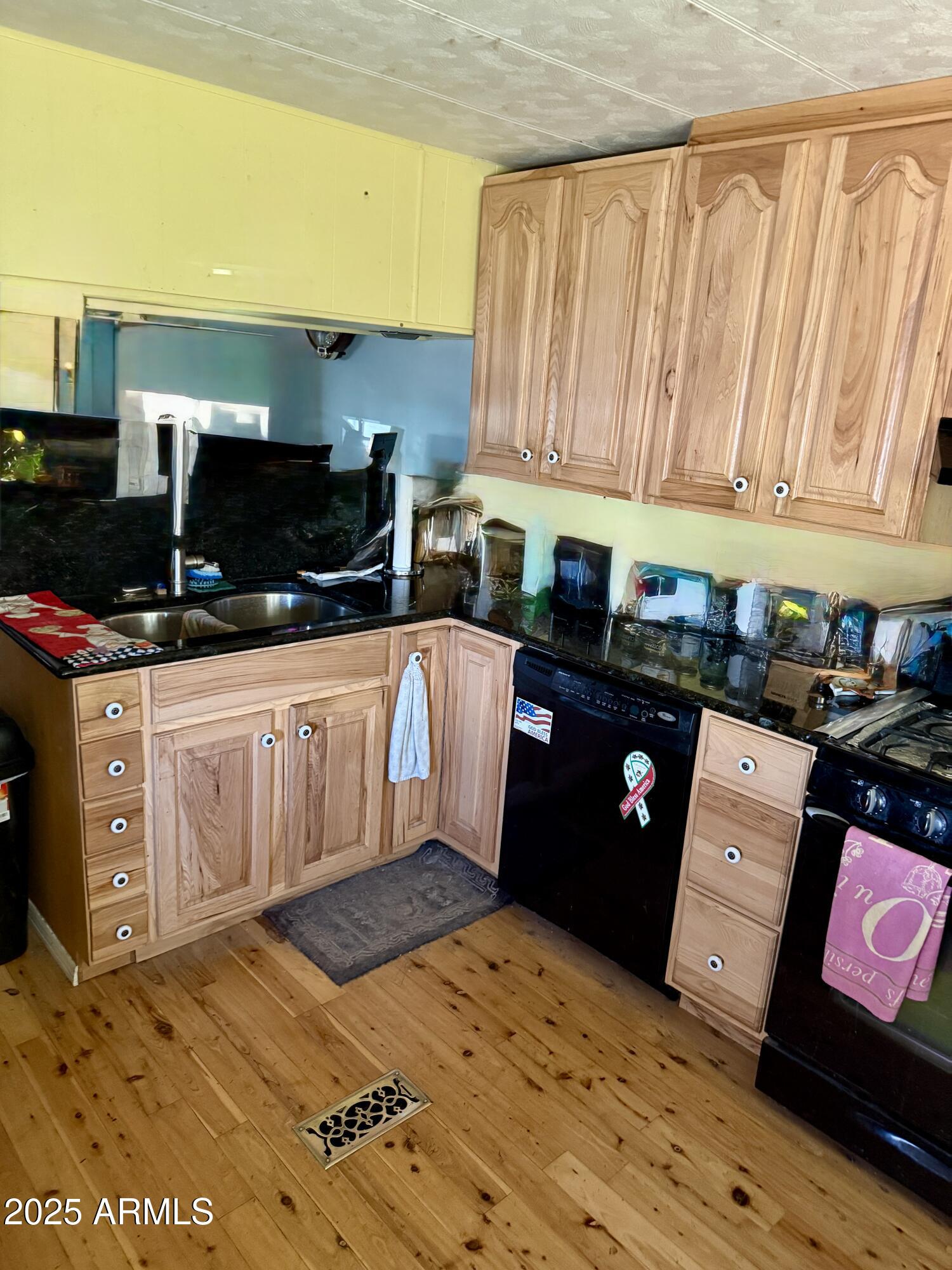 a kitchen with stainless steel appliances kitchen island granite countertop a stove a sink and a microwave