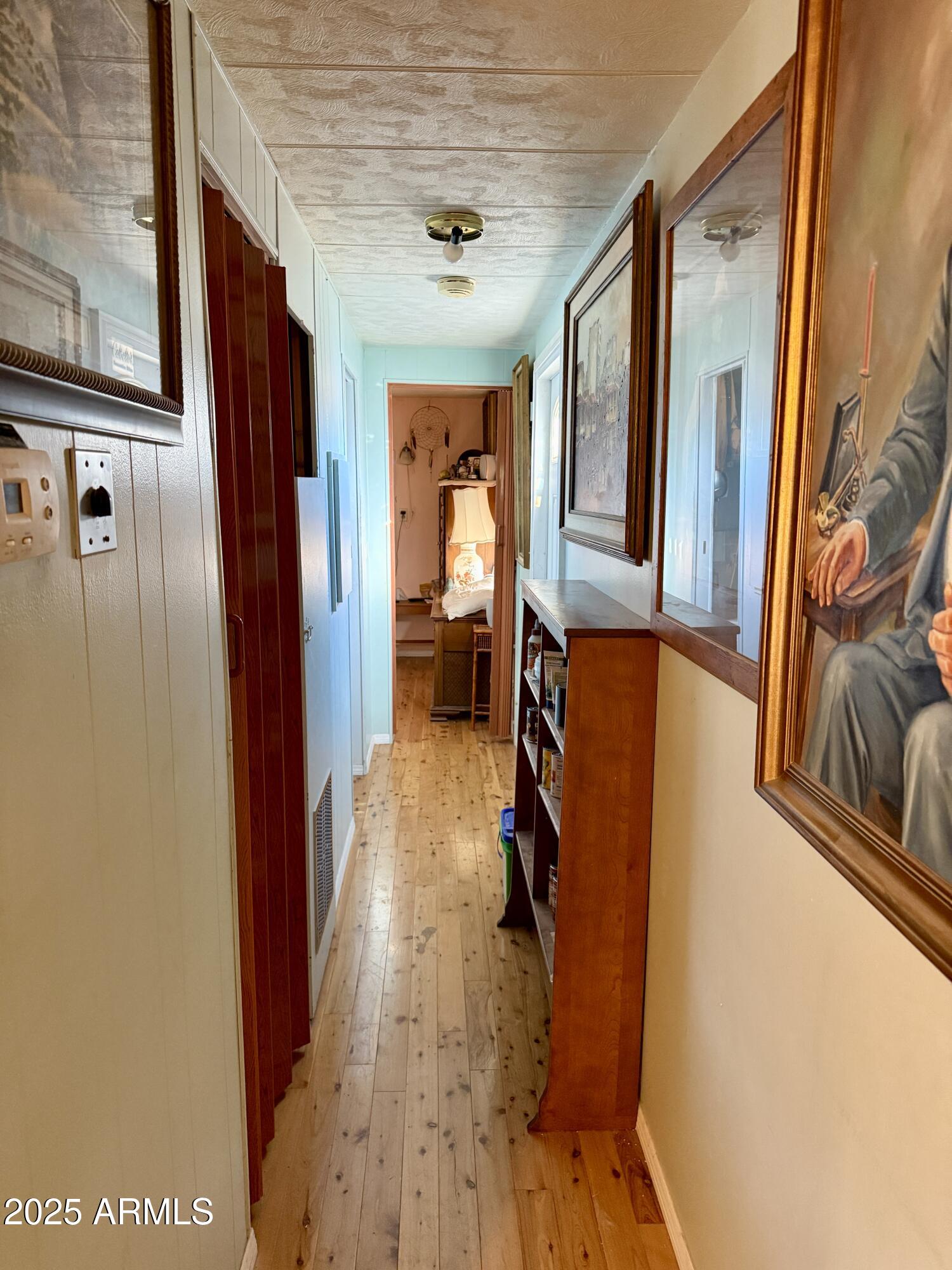 425 East McKellips Road, Unit 110 Mesa, AZ 85203 - Photo 2 of 5 a view of a hallway with wooden floor and furniture