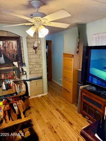 a bedroom with a bed and a flat tv screen on dresser