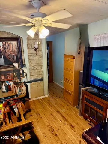 a bedroom with a bed and a flat tv screen on dresser