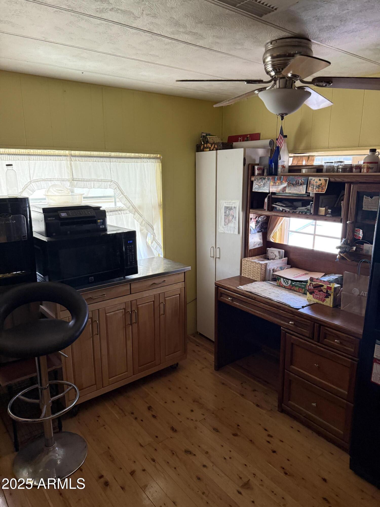 425 East McKellips Road, Unit 110 Mesa, AZ 85203 - Photo 4 of 5 a kitchen with stainless steel appliances wooden cabinets and a stove